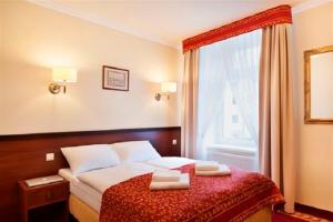 Posteľ alebo postele v izbe v ubytovaní Resort de Esperanto Sanatorium Uzdrowiskowe