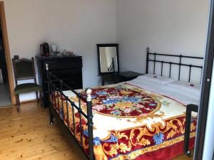 a bedroom with a bed and a dresser and a mirror at Casa Ines in Bellinzona