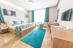 a hotel room with a bed and a desk at Boutique hotel Villa Beatika in Český Krumlov