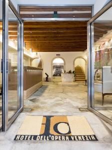 a lobby with glass doors and a hotel sign on the floor at Hotel Dell'Opera in Venice