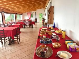 a long table with food on it in a restaurant at Agriturismo Madonna Dei Ceppi in Lezzeno +61 photos