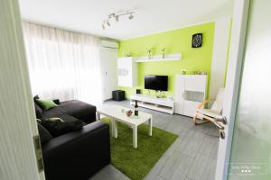 a living room with a couch and a table at Emerald Soca Apartment in Tolmin