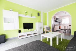 a living room with a tv and a table at Emerald Soca Apartment in Tolmin