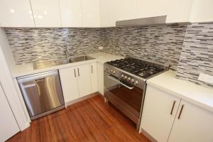 a kitchen with a stove and a sink at Ballarat Premier Apartments in Ballarat