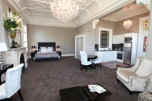 a large room with a bed and a living room at Ballarat Premier Apartments in Ballarat