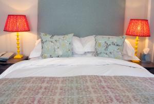 a bedroom with a bed with two lamps and two pillows at Sea Spray Hotel in Brighton & Hove
