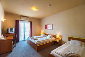 A bed or beds in a room at Beach Hotel