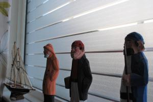 two figurines of people standing in front of a garage at The Royson Guest House in Shanklin