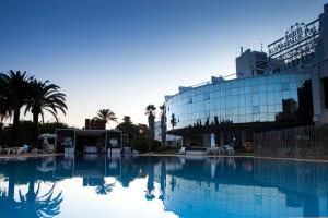 una grande piscina d'acqua di fronte a un edificio di Silken Al-Andalus Palace a Siviglia