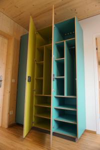a closet with green and yellow doors in a room at Hostel Salzburg-Wals in Salzburg