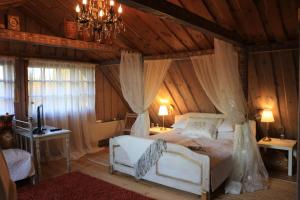 a bedroom with a bed in a room with wooden walls at Ziemeļu terases in Sausnēja