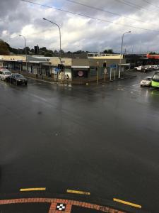 a parking lot with cars parked in front of a building at The Kamo Hotel in Whangarei
