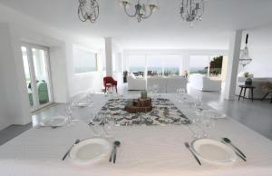 a table with wine glasses and a white table cloth at PG - Beach House in Sintra