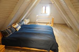 a bedroom with a large bed in a attic at Fischerhus In Krummin - nur für Urlauber in Krummin
