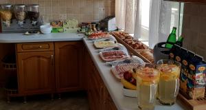 a kitchen with a counter with food and drinks on it at Park7 in Tiszafüred