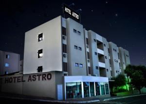 a hotel at night with a street sign on top of it at Astro Palace Hotel in Uberlândia