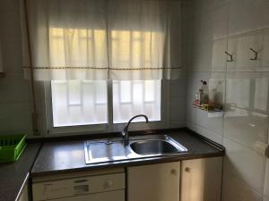 a kitchen with a sink and a window at Cala Azul 304-306 Tamarit in Tamarit