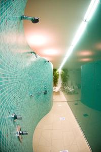 a bathroom with a shower and a glass wall at Hotel Angelika in Neustift im Stubaital