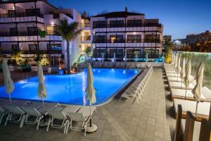 a swimming pool in front of a building at Vanilla Garden Boutique Hotel - Adults Only in Playa de las Americas