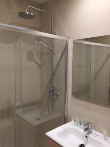 a bathroom with a shower and a sink and a mirror at Las Américas - Mares in Torre del Mar