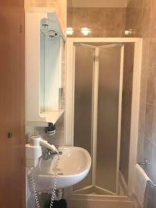 a bathroom with a white sink and a shower at Hotel Cinzia in Savignano sul Panaro
