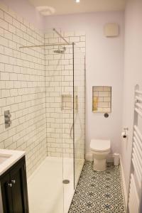 a bathroom with a glass shower with a toilet at Seaview in Worthing