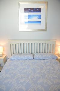 a bed in a bedroom with a picture on the wall at Seaview in Worthing