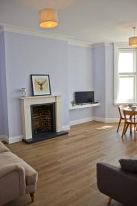 a living room with a couch and a fireplace at Seaview in Worthing
