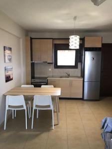 a kitchen with a table and chairs and a refrigerator at Stone House in Afytos in Afitos +21 photos