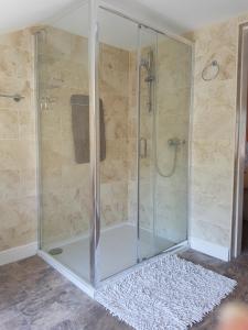 a shower with a glass enclosure in a bathroom at Riverside Guest House in Sleaford