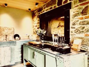 an old kitchen with a sink and a stone wall at PIPPO'S LITTLE RESORT/2 in Poppi