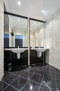a bathroom with two sinks and a large mirror at Botabara Del Mar Apartments in Pomorie +25 photos