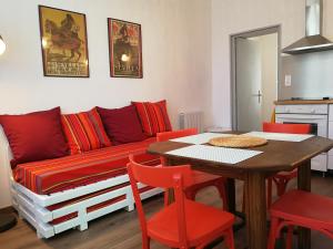 a living room with a couch and a table and chairs at La Loge du Theatre - Saintes in Saintes