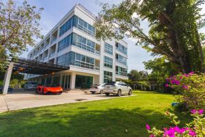two cars parked in front of a building at The Pano Hotel & Residence in Ao Nang Beach