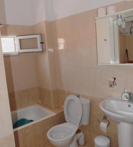 een badkamer met een toilet, een wastafel en een bad bij Faraggi Richti House in Éxo Moulianá