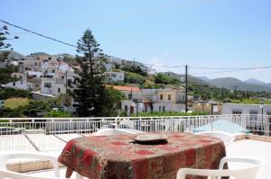 a table and chairs on a balcony with a view at Faraggi Richti House in Éxo Moulianá