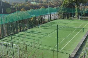 a tennis court with two tennis nets on it at Carpediem Assisi Living Club in Piano Delle Pieve