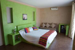 a green bedroom with a bed and a couch at La Taniere Villa Metsu in Saly Portudal +63 photos