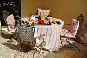 a table with a white table cloth and chairs at A CASA DA LISA (exclusive room) in Turi