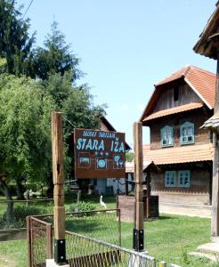 a sign in front of a building with a house at Stara Iža in Selišće Sunjsko