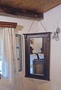 a mirror hanging on a wall next to a window at Stara Iža in Selišće Sunjsko