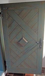a wooden door with a wooden pattern on it at Stara Iža in Selišće Sunjsko