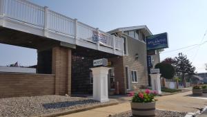a building with a balcony on top of it at Atlantic Motel in Point Pleasant Beach