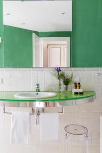 a bathroom with a sink and a green mirror at Hotel Piccolo Sant'Andrea in Praiano