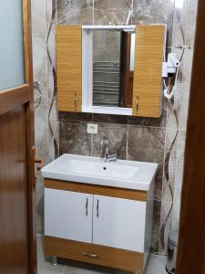 a bathroom with a white sink and a mirror at Uzungol Comfort Residence in Uzungöl +31 photos