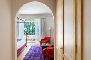 a room with a bed and a chair and a table at Hotel Piccolo Sant'Andrea in Praiano