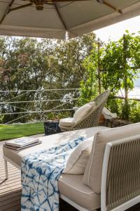 a table and chairs on a deck with an umbrella at Hotel Piccolo Sant'Andrea in Praiano
