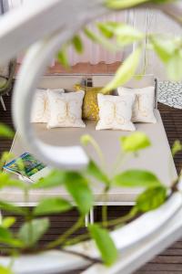 a bed with four pillows on it at Hotel Piccolo Sant'Andrea in Praiano
