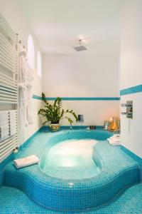 a bath tub in a room with blue tiles at Hotel Piccolo Sant'Andrea in Praiano