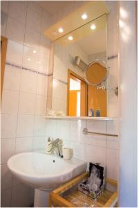 a bathroom with a sink and a mirror at Apartments Maja in Podstrana +14 photos